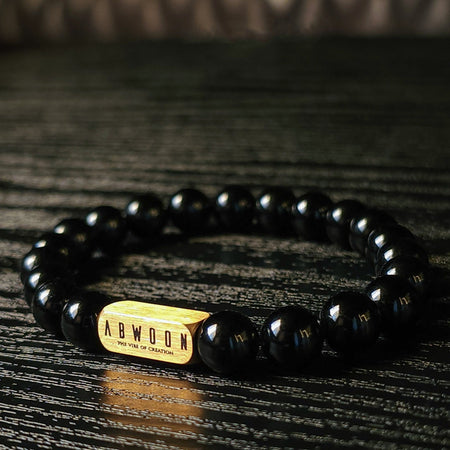 A sophisticated Onyx bracelet with a gold accent Holistic Warrior Stones bead.